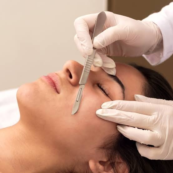 Dermaplaning facial exfoliation and peach fuzz removal treatment at Nail Bahar salon.