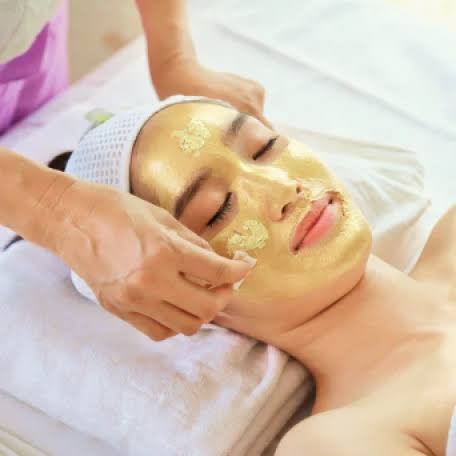 Gold foil facial mask application for luxury skincare at Nail Bahar salon.