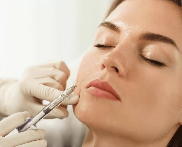 Cosmetic facial filler injection procedure at Nail Bahar salon.