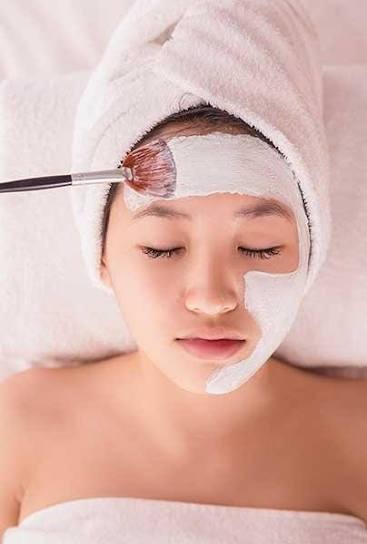 Clay mask brush application for purifying facial skincare at Nail Bahar salon.